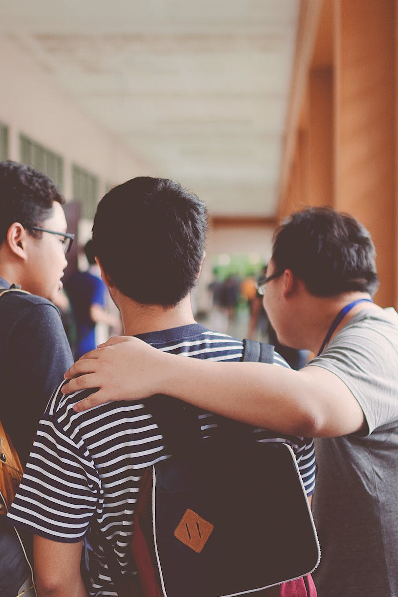 Three Men Standing Near Window